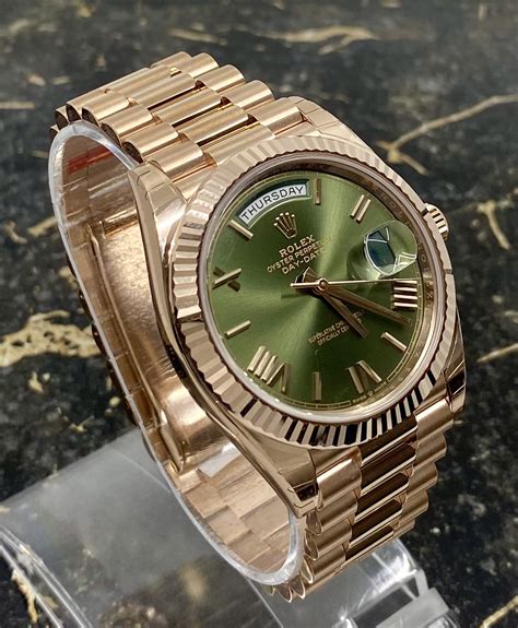 rolex gold green day date.